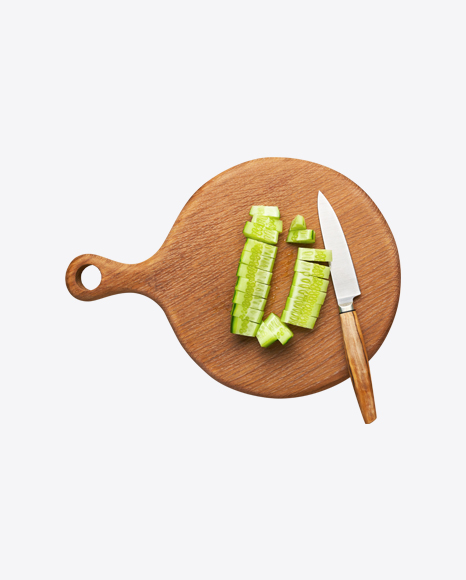 Chopped Cucumber w/ Knife on Wooden Board