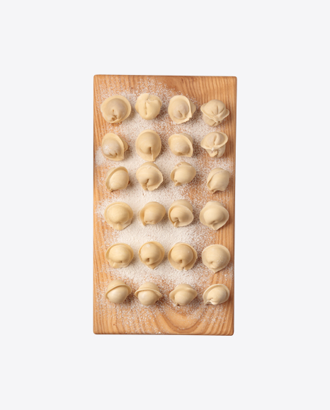 Raw Pelmeni on Wooden Board